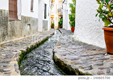 Pampaneira, in the Alpujarra region of Granada, with its narrow, steep streets and water channels running through them Pampaneira, in the Alpujarra region of Granada, with its narrow, steep streets and water channels running through them 140605700
