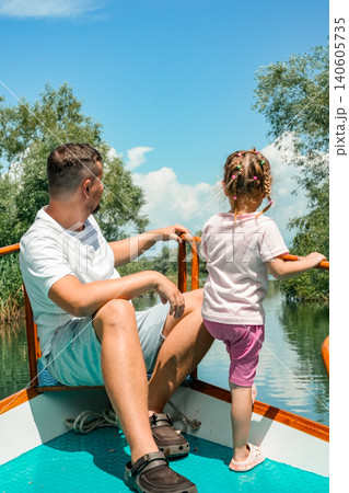 Family on boat bow looking over lake Skadar Montenegro travel adventure wide view Family on boat bow looking over lake Skadar Montenegro travel adventure wide view 140605735