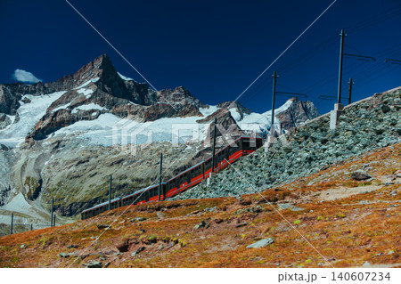 Red train in high Alps mountains Red train in high Alps mountains 140607234