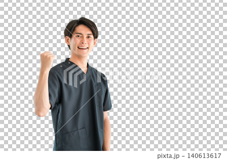 A young Asian man wearing a scrub and pumping his fist in a gesture of approval A young Asian man wearing a scrub and pumping his fist in a gesture of approval 140613617