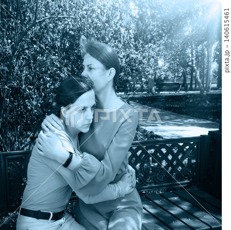 Two girls hug one another 140615461