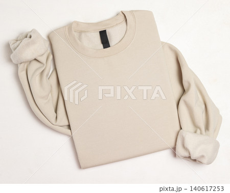Blank beige unisex sweatshirt mockup, folded apparel template with copy space on front 140617253