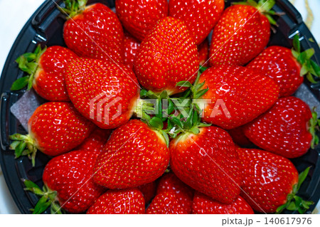 Fresh organic strawberries background, Fresh ripe organic strawberry in a dark plate Fresh organic strawberries background, Fresh ripe organic strawberry in a dark plate 140617976