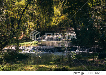 Monasterio de Piedra: Sunny Day, Small Waterfalls, Wooden Bridge, Verdant Surroundings Monasterio de Piedra: Sunny Day, Small Waterfalls, Wooden Bridge, Verdant Surroundings 140618295