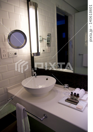 Fujairah, United Arab Emirates, November 04 2017: Bathroom vanity with white tiles and large mirror in luxury hotel Fujairah, United Arab Emirates, November 04 2017: Bathroom vanity with white tiles and large mirror in luxury hotel 140618601