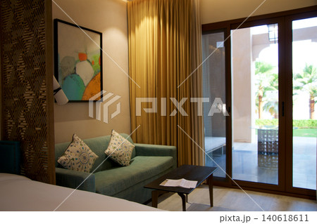 Al Marjan Island, United Arab Emirates, November 11 2017: Hotel room with sofa and terrace view Al Marjan Island, United Arab Emirates, November 11 2017: Hotel room with sofa and terrace view 140618611
