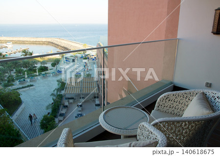 Fujairah, United Arab Emirates, November 04 2017: Balcony with wicker furniture and sea view in luxury hotel Fujairah, United Arab Emirates, November 04 2017: Balcony with wicker furniture and sea view in luxury hotel 140618675