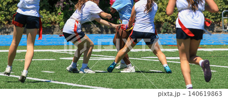 Girls Play Flag Football on a Field Girls Play Flag Football on a Field 140619863