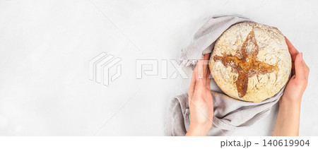 Hands holding artisan sourdough bread on light background, homemade bakery concept with copy space Hands holding artisan sourdough bread on light background, homemade bakery concept with copy space 140619904