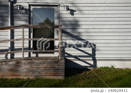 house entrance with wooden deck and geometric shadows house entrance with wooden deck and geometric shadows 140620411