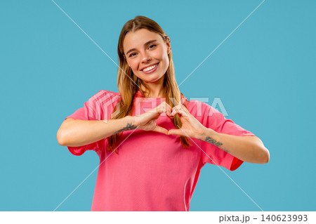 Smiling Charming Woman Showing Sign Of Shape Heart. Romantic Woman On Blue Smiling Charming Woman Showing Sign Of Shape Heart. Romantic Woman On Blue 140623993
