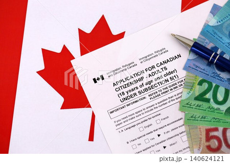 Canadian application for citizenship with money on Canadian flag Canadian application for citizenship with money on Canadian flag 140624121