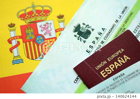 Spanish passport lies on citizenship or naturalization documents on flag of Spain 140624144