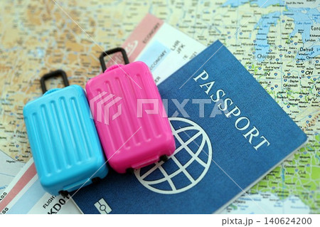 Passport with boarding pass tickets and toy luggage bag on United States map Passport with boarding pass tickets and toy luggage bag on United States map 140624200