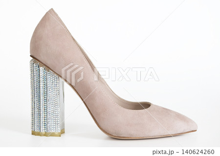 Elegant beige suede pump with silver block heel on clean white background fashion image Elegant beige suede pump with silver block heel on clean white background fashion image 140624260