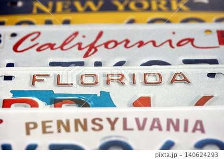 Old US car license plates with various state names close up. Concept of driving in United States Old US car license plates with various state names close up. Concept of driving in United States 140624293