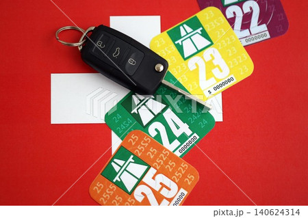 Switzerland vignette stickers with ignition key on Swiss flag close up. Driving permit 140624314