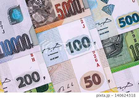 Congolese franc money bills in big amount on table close up. Rich life concept in Congo Congolese franc money bills in big amount on table close up. Rich life concept in Congo 140624318