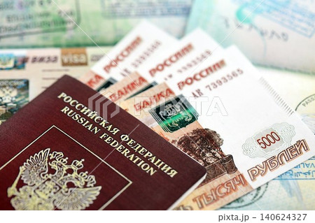 Fragment of Russian Federation visa in passport page and russian money Fragment of Russian Federation visa in passport page and russian money 140624327
