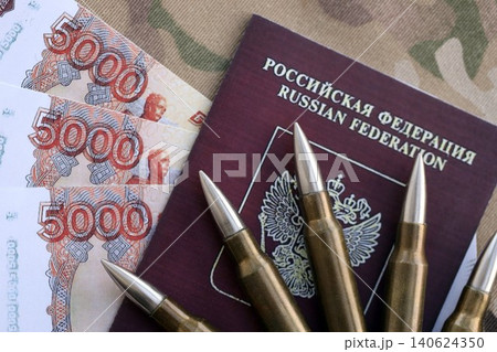 Russian money with bullets on passport and multicam camouflage fabric close up. Russian army funds 140624350
