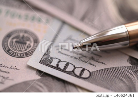 One hundred US dollar bills and silver pen close up. Concept of business calculating and accounting 140624361