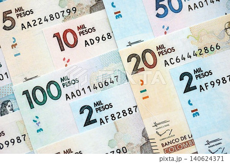 Colombian pesos money bills banknotes lies in big pile on table close up. Finances and business 140624371