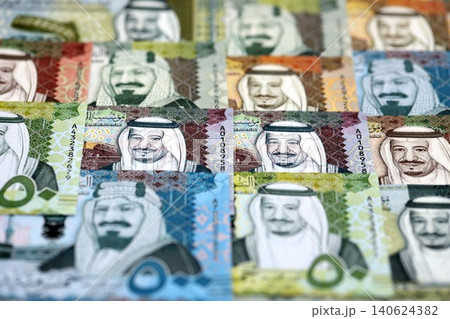 Saudi Arabia riyal money bills banknotes lies in big pile on table. Business in Saudi Arabia 140624382