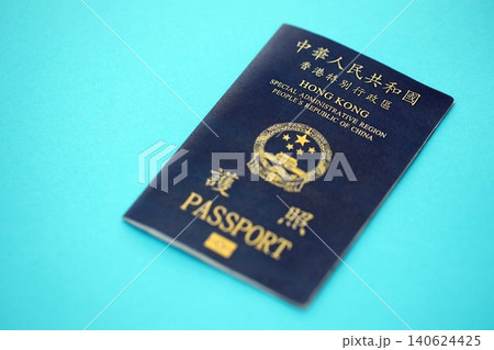 Hong Kong Special Administrative Region HKSAR Passport lies on blue table background close up Hong Kong Special Administrative Region HKSAR Passport lies on blue table background close up 140624425