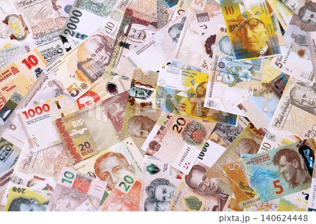 Various currencies money bills banknotes in yellow and orange color. Many cash bills Various currencies money bills banknotes in yellow and orange color. Many cash bills 140624448