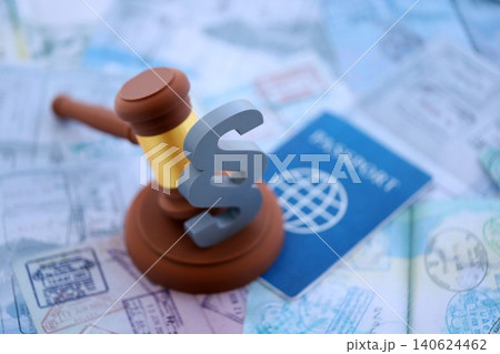 Judgement gavel and paragraph symbol on passport pages full of colorful stamps after travel Judgement gavel and paragraph symbol on passport pages full of colorful stamps after travel 140624462