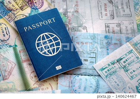 One fictional passport on big amount of passport pages full of colorful stamps after travel One fictional passport on big amount of passport pages full of colorful stamps after travel 140624467