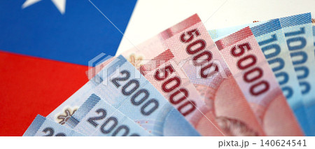 Chile Republic pesos money bills banknotes on flag close up. Chilean money Chile Republic pesos money bills banknotes on flag close up. Chilean money 140624541