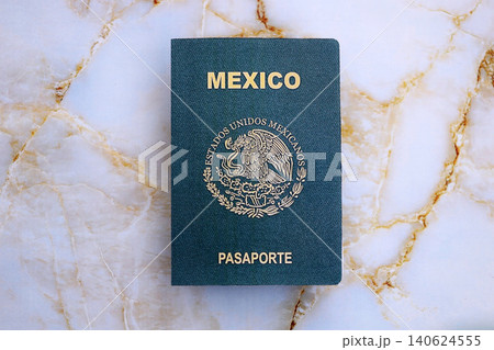 Mexican passport on table close up. Official identification document book for citizens of Mexico Mexican passport on table close up. Official identification document book for citizens of Mexico 140624555