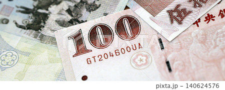 Taiwanese dollar paper banknotes pile on table. Taiwan TWD currency money bills in big amount 140624576