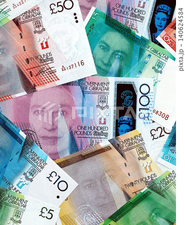 Gibraltar pound paper banknotes pile on table. Gibraltar GIP currency money bills in big amount Gibraltar pound paper banknotes pile on table. Gibraltar GIP currency money bills in big amount 140624584