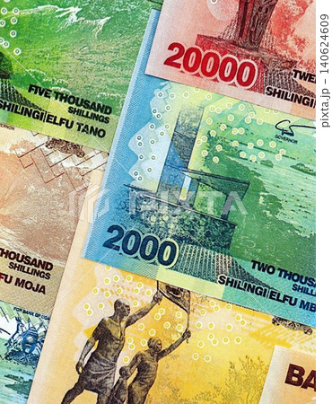 Ugandan shilling paper banknotes pile on table. Uganda UGX currency money bills in big amount 140624609