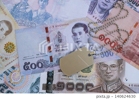 Thai baht currency money bills and military token. The concept of army service Thai baht currency money bills and military token. The concept of army service 140624630