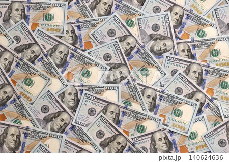 Stacks of hundred dollar bills showcase intricate designs on a flat surface 140624636
