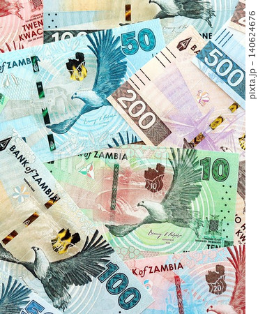 Zambian kwacha money bills pile on table. Zambia banknotes of ZMW currency close up Zambian kwacha money bills pile on table. Zambia banknotes of ZMW currency close up 140624676