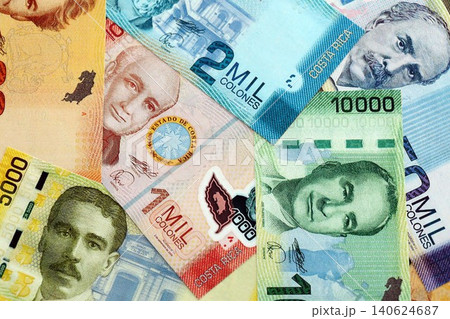 Costa Rican old colon money bills pile on table. Costa Rica banknotes of CRC currency close up Costa Rican old colon money bills pile on table. Costa Rica banknotes of CRC currency close up 140624687