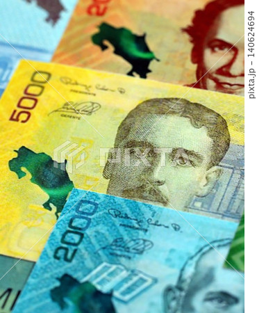 Costa Rican colon money bills pile on table. Costa Rica banknotes of CRC currency close up Costa Rican colon money bills pile on table. Costa Rica banknotes of CRC currency close up 140624694