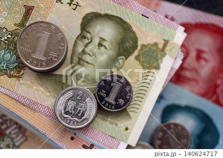 Chinese yuan money bills and jiao coins pile on table. China coins on banknotes of CNY currency 140624717
