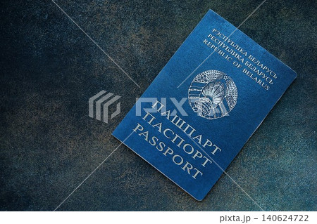 Belarusian passport on table close up. Official identification document book for citizens of Belarus Belarusian passport on table close up. Official identification document book for citizens of Belarus 140624722