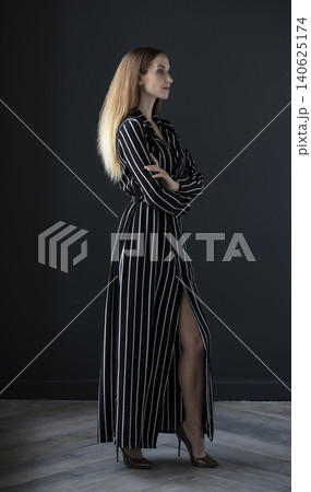 young beautiful woman on a dark background, full length studio shot young beautiful woman on a dark background, full length studio shot 140625174