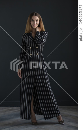 young beautiful woman on a dark background, full length studio shot young beautiful woman on a dark background, full length studio shot 140625175