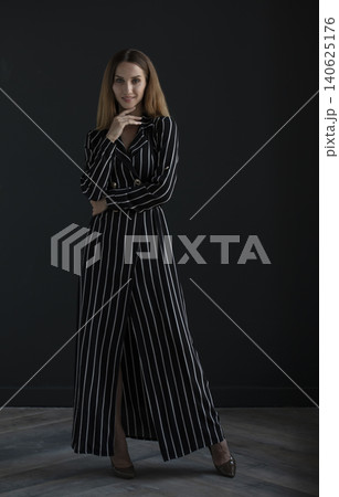 young beautiful woman on a dark background, full length studio shot young beautiful woman on a dark background, full length studio shot 140625176