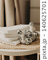 Minimalist still life of luxury spa essentials. White cotton towels with visible textured on a table. 140625701
