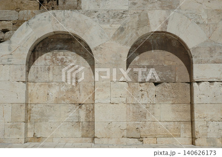 Ancient stone archways on the lower facade of Odeon of Herodes Atticus Athens Greece 140626173