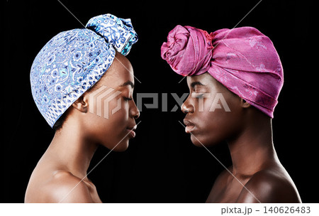 Studio, sisters and black women with skincare for beauty, profile and head wrap for aesthetic. Dark background, African female people and glow with shine of face, cosmetics and dermatology results Studio, sisters and black women with skincare for beauty, profile and head wrap for aesthetic. Dark background, African female people and glow with shine of face, cosmetics and dermatology results 140626483
