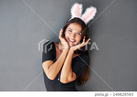 Bunny ears, happy or portrait of woman with fashion isolated on wall or grey background with style. Funny joke, confident lady or casual female person in studio with pride, smile and trendy clothes 140626565